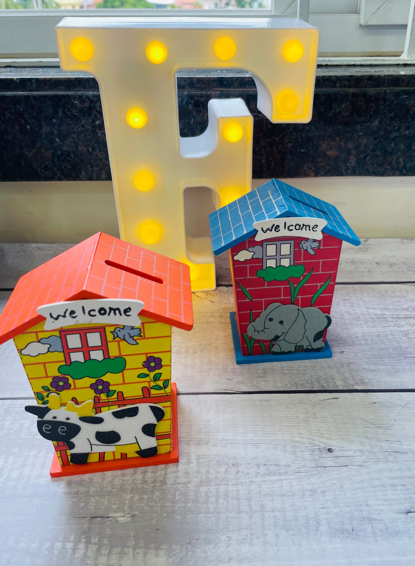 Wooden piggy banks in assorted colours